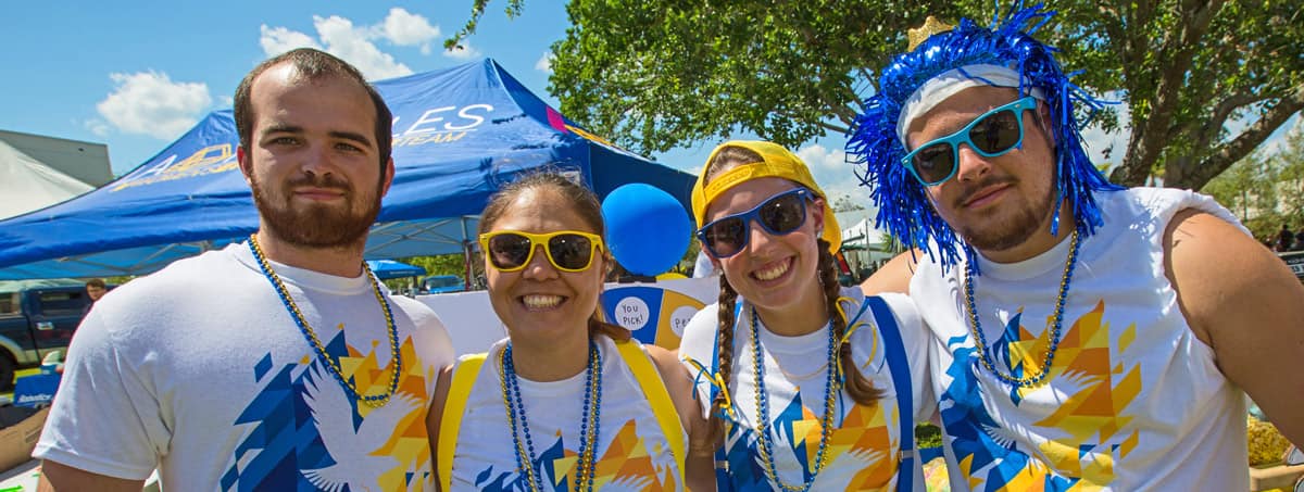 Four students banner on blue & gold week