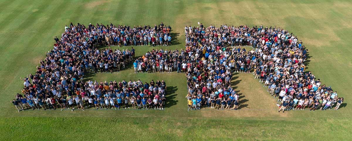 Students form a large E and R in a field.