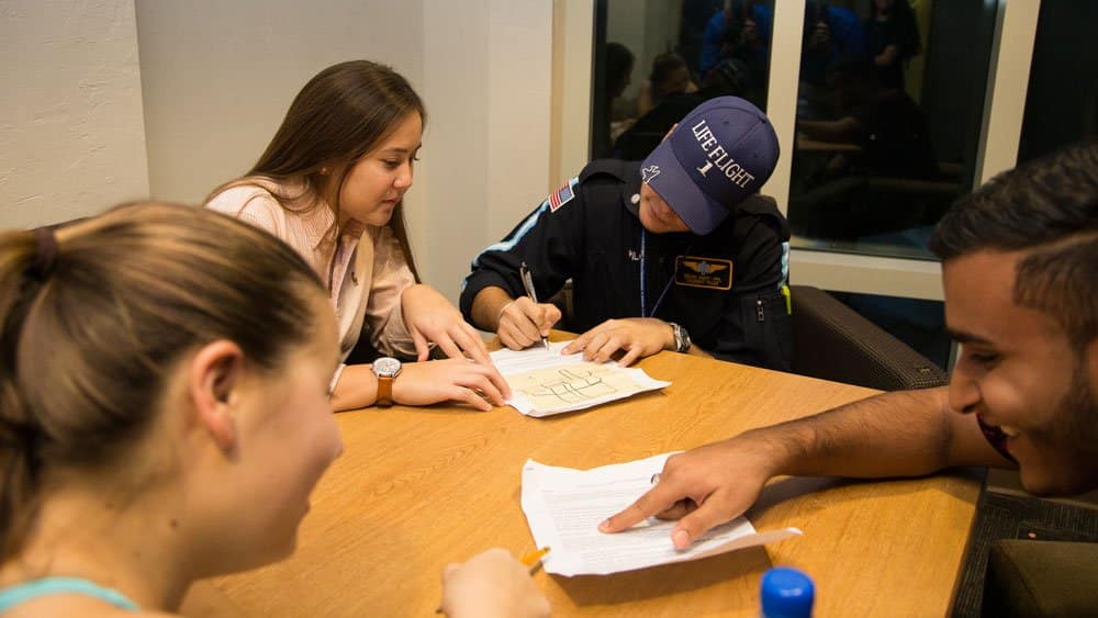 Students work in a group at the Embry-Riddle Daytona Beach College for Business Living and Learning building.