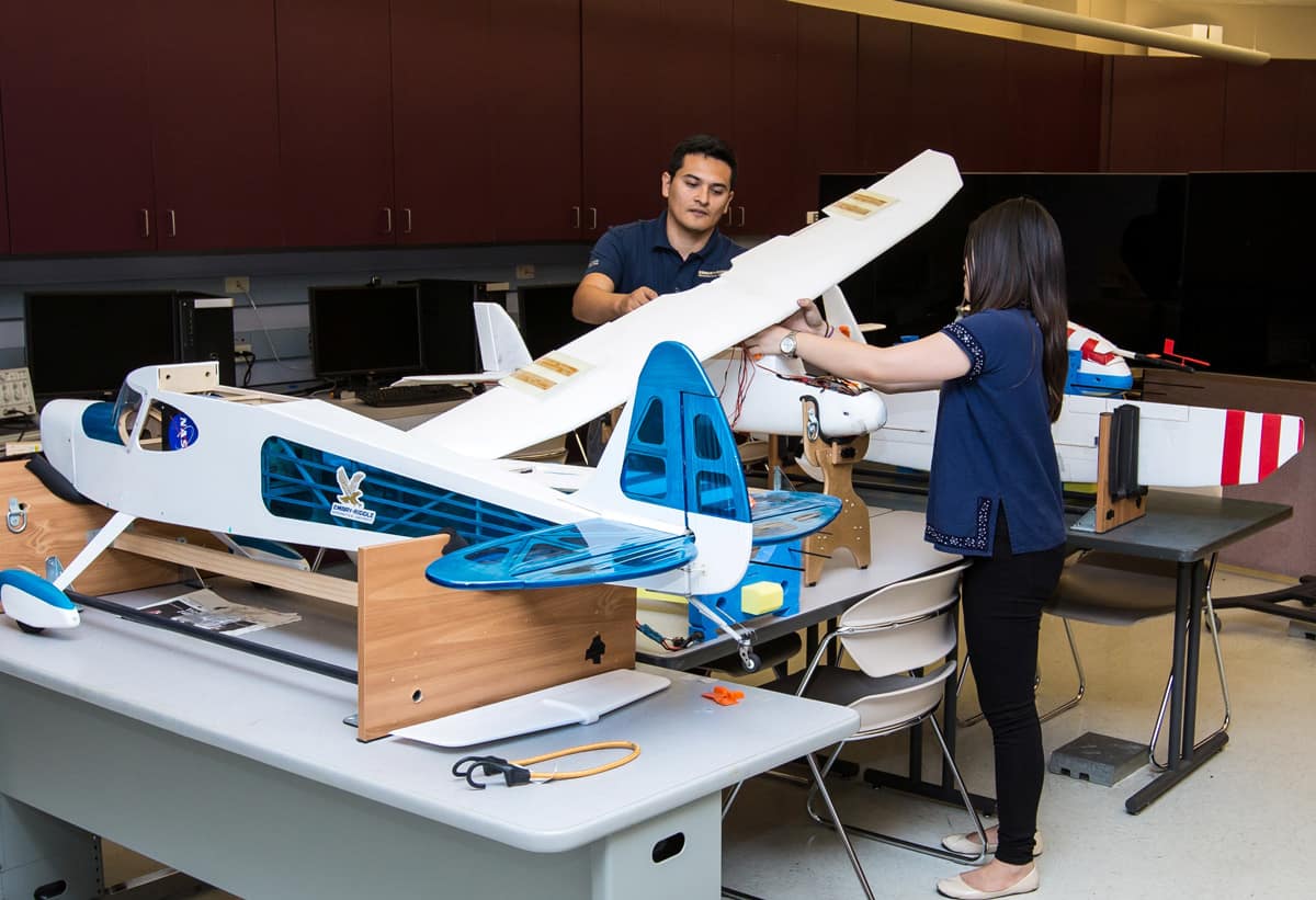 Student and faculty working on model plane.