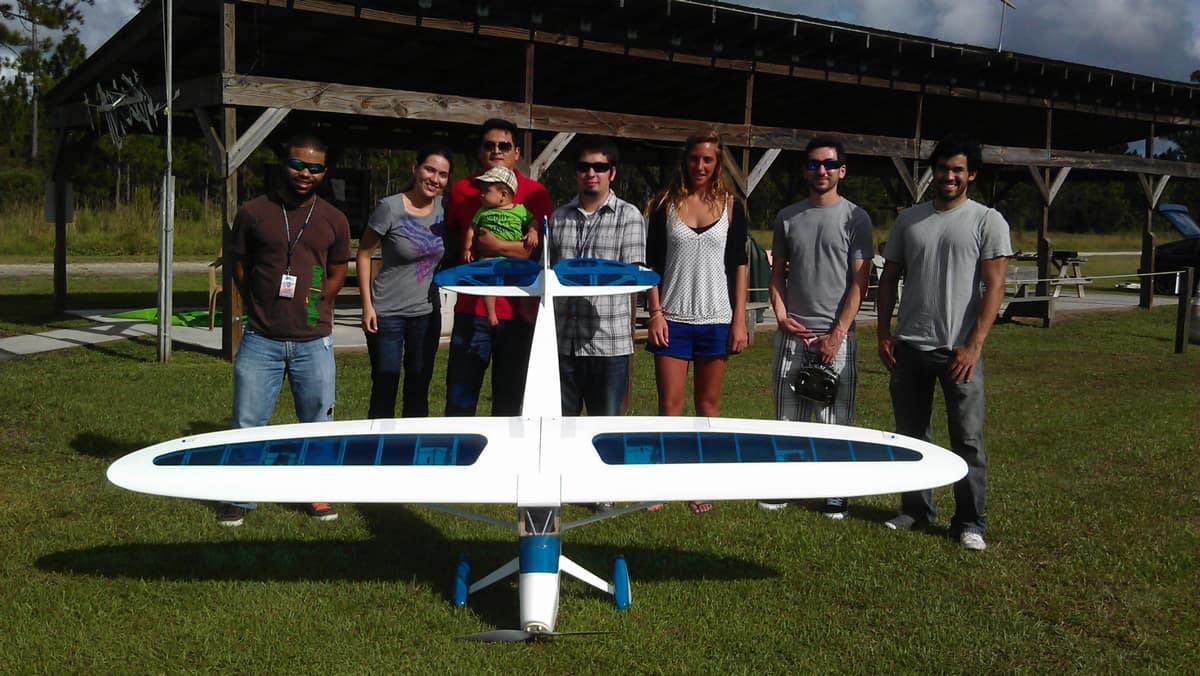 Students stand with a drone