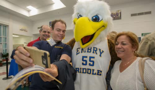 a student and his parents take a selfie with Ernie the Eagle