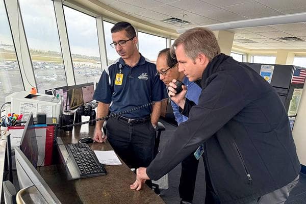 Embry-Riddle researchers Dr. Jianhua Liu and Andrew Schneider with lead flight supervisor Chris Deputy (left) in the Flight Supervisor Tower