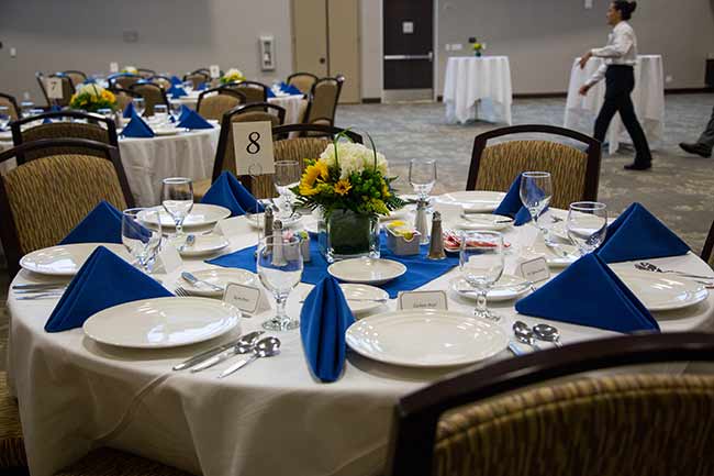 Tables set up for dinner at the College of Business