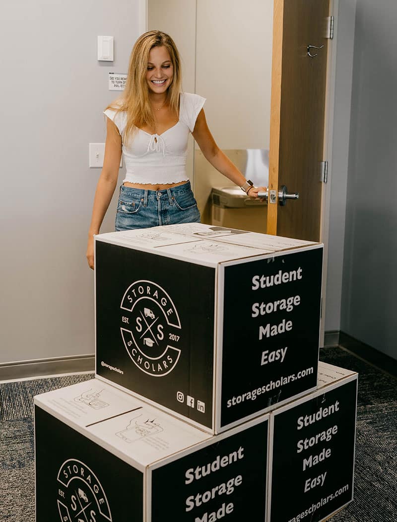 Woman enters room to find stack of moving boxes