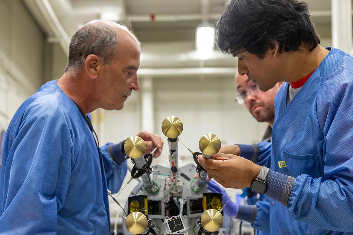 Mechanical technician John Peterson, of NASA’s Wallops Flight Facility, and Dr. Barjatya check the six booms carrying the sensitive science sensors after a successful spin deployment testing.