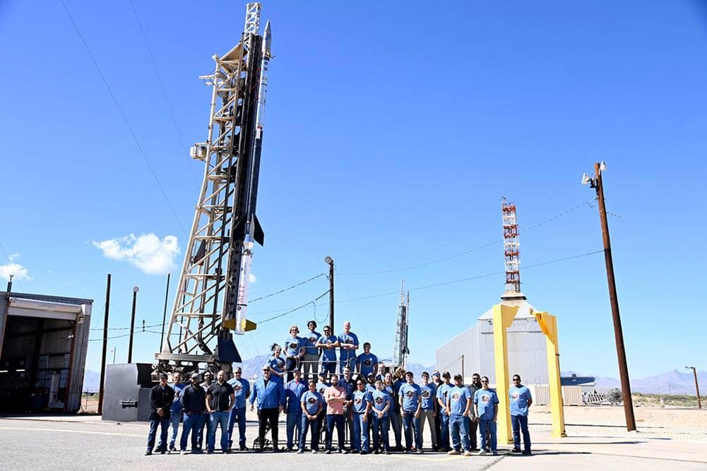 The APEP team standing in front of two missiles at White Sands Missile Range in New Mexico