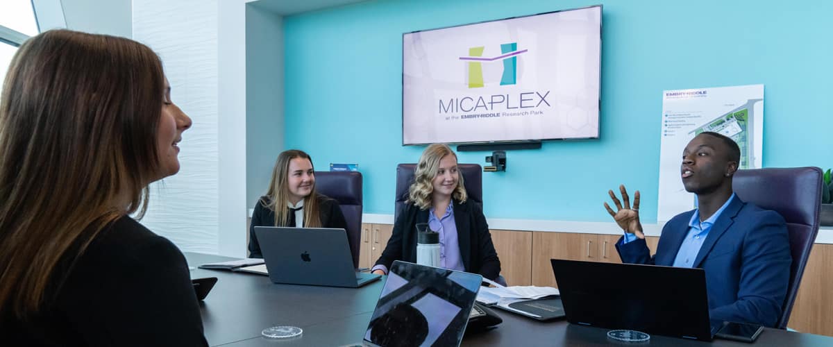 People look at a digital display in the MicaPlex