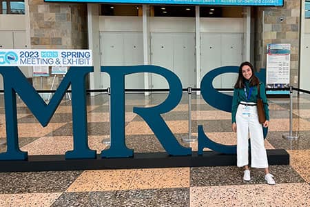 Perla stands in front of the MRS sign