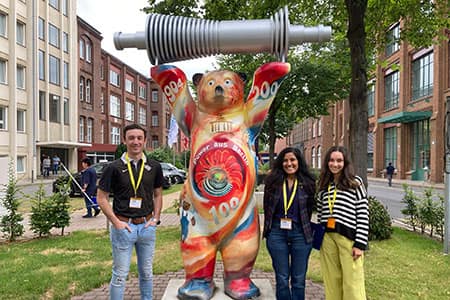 Mike and Perla pose with a tie-dye bear sculpture in Berlin