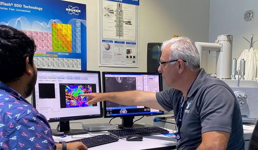 Dr. Mello shows a student how a Scanning Electron Microscope is being used for topographic analysis and electron backscattered diffraction mapping at the MicaPlex.