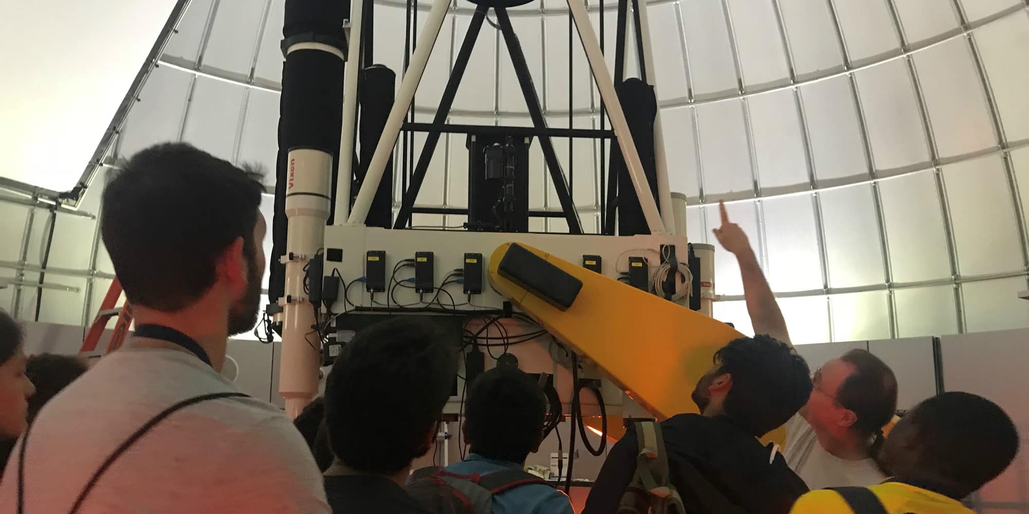 students check out the telescope on campus