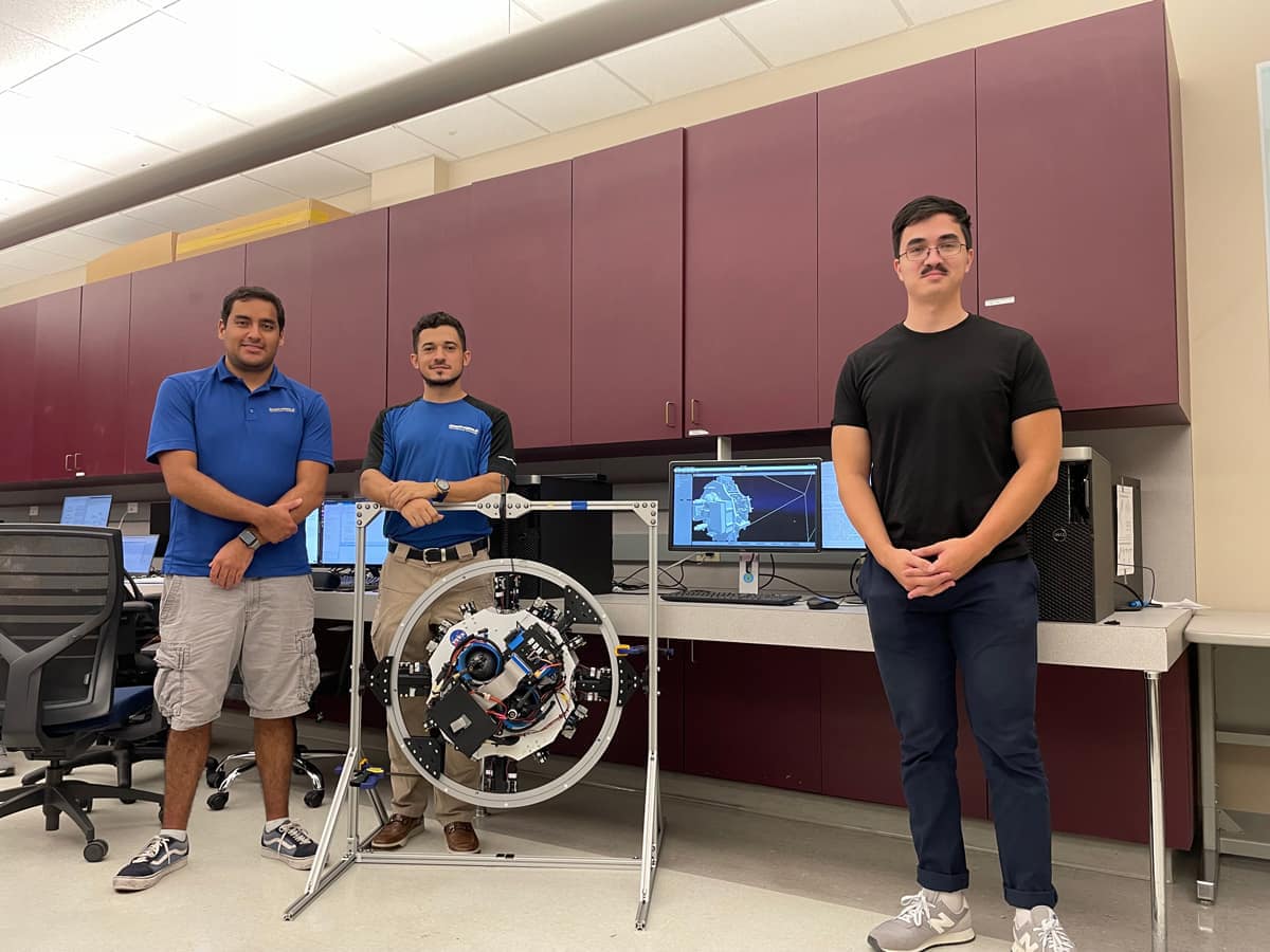 Students pose with a robot