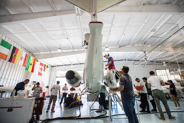 Students work on plane in AMS Hangar