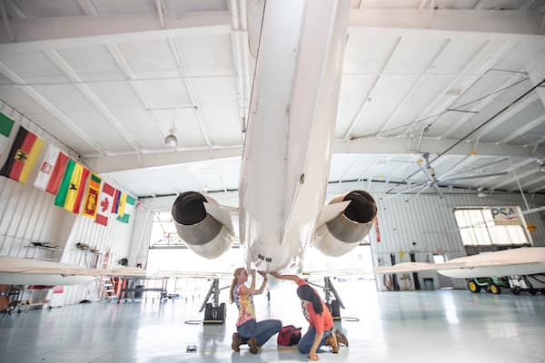 Students work on plane in AMS Hangar