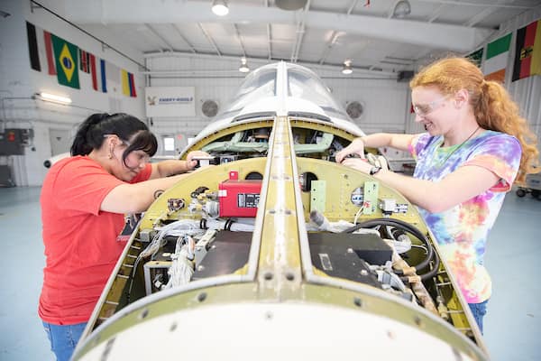 Students work on plane in AMS Hangar