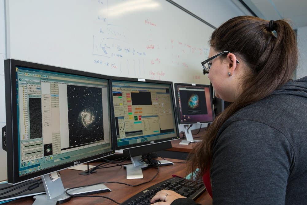 A student works on a computer in the Astrophysics and Controls Lab