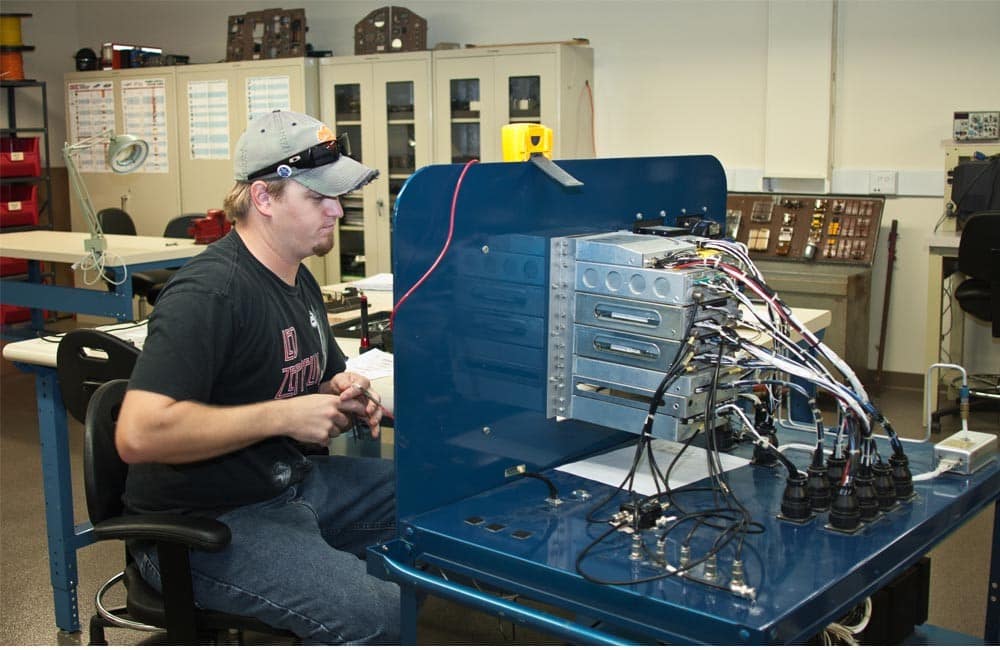 A student works on electronics in the Electrical Lab