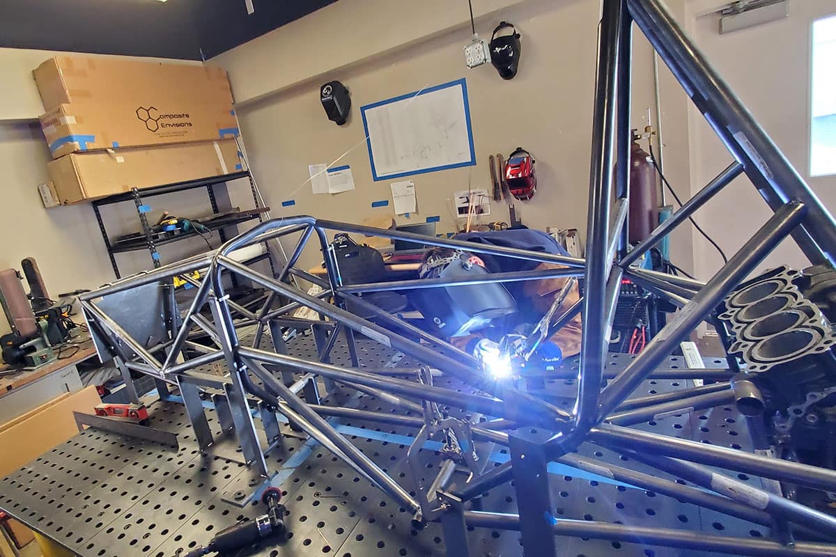 A Mechanical Engineering student welds the ER06 Chassis in the Formula SAE Lab