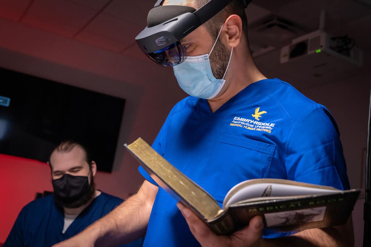 Man in medical gear works in a lab.