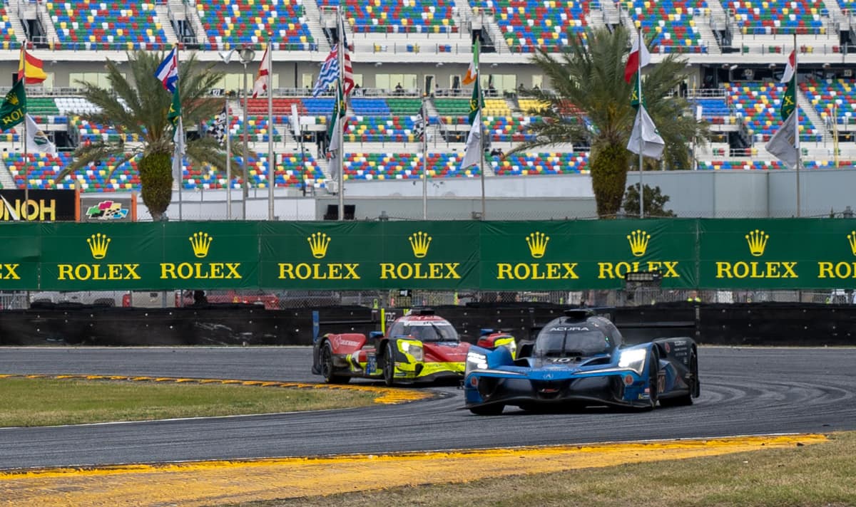 Two Acuras go through a turn at the 24-hour race