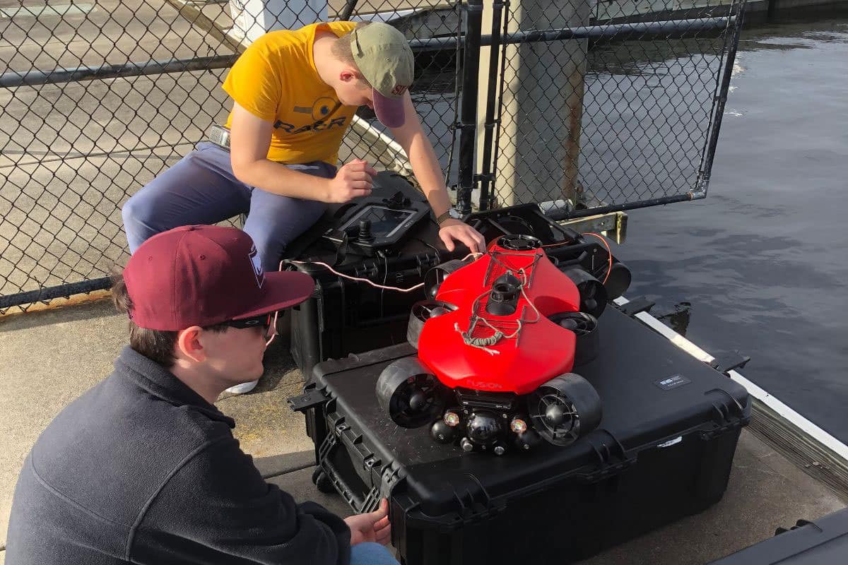 Research students Matthew Helms and Parker Tyson prepare the FUSION USV to collect SONAR data for use in deep-learning perception research. (Photo: Dr. Eric Coyle)