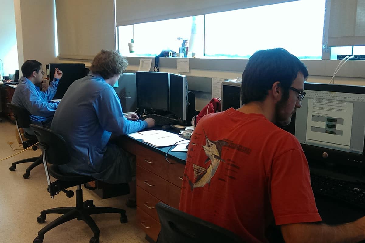 Three students working in front of computers