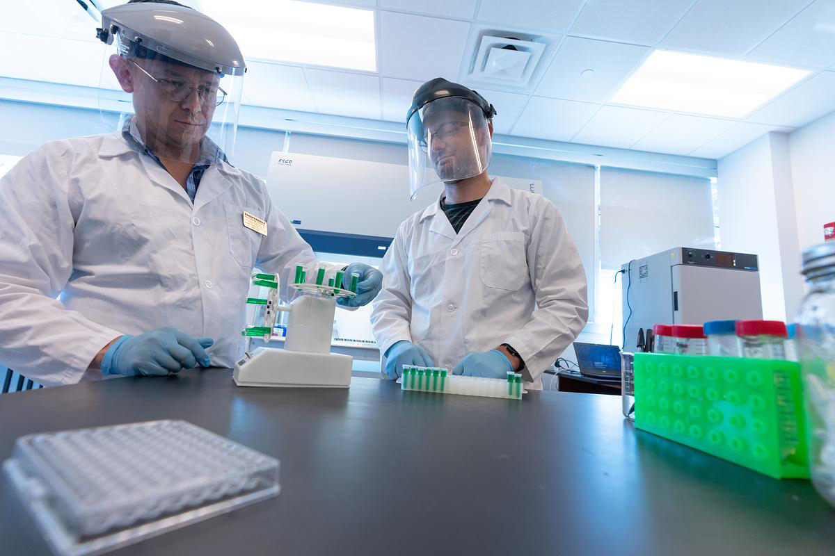 Dr. Hugo Castillo and Embry-Riddle student Collin Topolski prepare samples to go into a 2D clinostat that simulates microgravity effects on the samples.