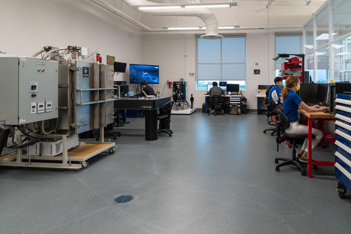 Engineering students Taylor Yow, Kevin Pepin, Daniel Posada, and Chris Hays work in the Space Technologies Lab.