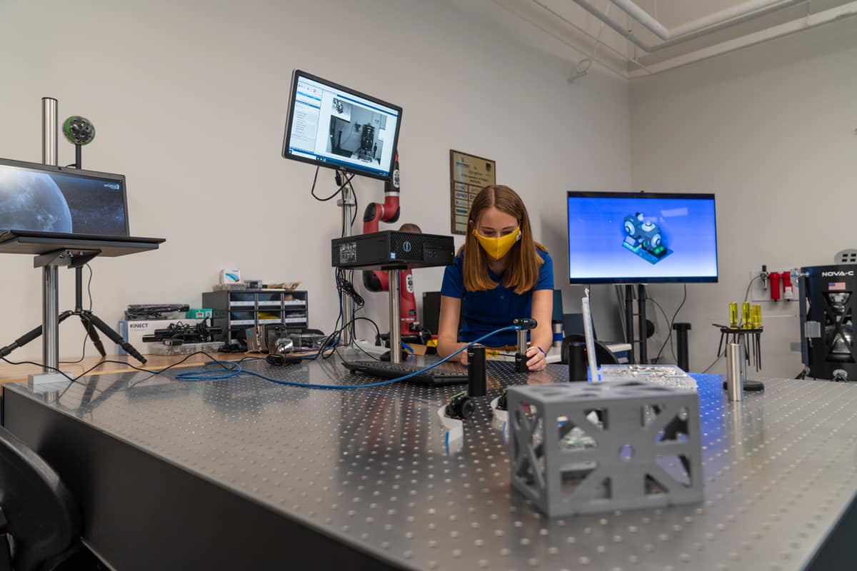Taylor Yow, an Aerospace Engineering student, works at the optical table in the Space Technologies Lab.