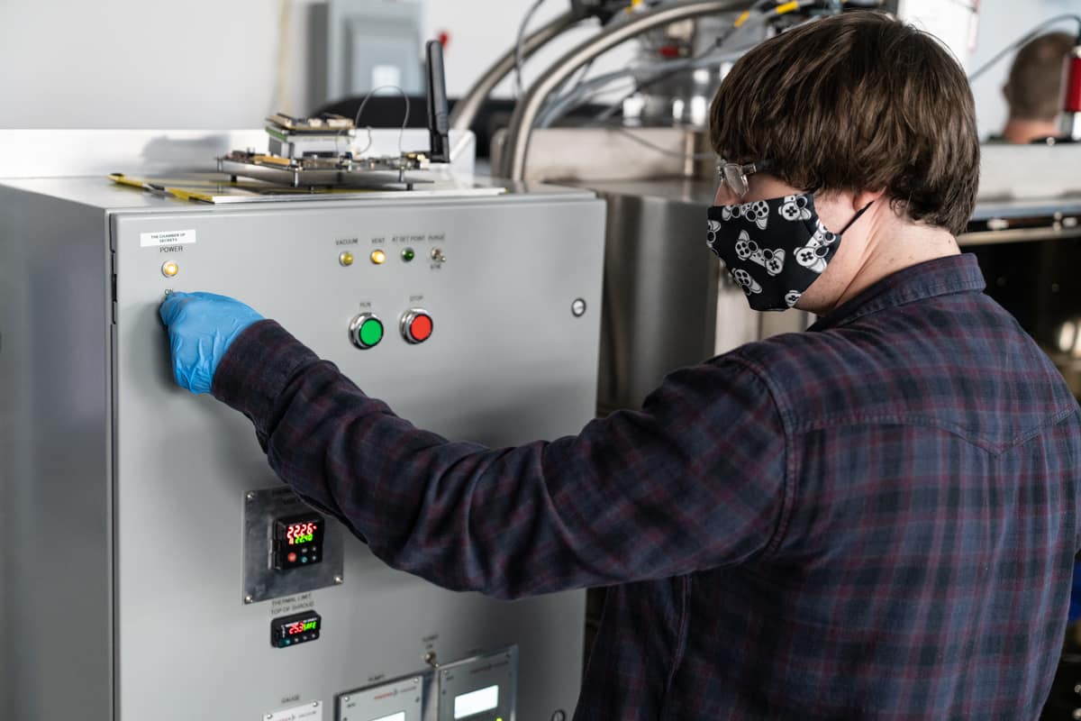 Kevin Pepin, a master's student in the Electrical and Computer Engineering degree program, uses the ultra high thermal vacuum chamber to test equipment for environmental space testing.
