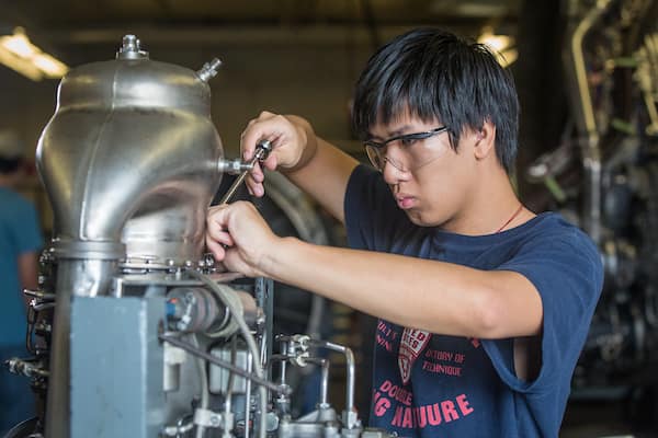 Student works on engine