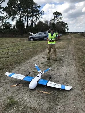 A researcher and drone out in the field
