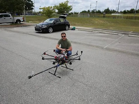 A researcher with a drone in the parking lot