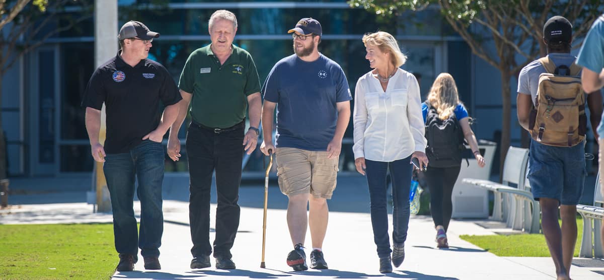 A group of veterans walk across campus.