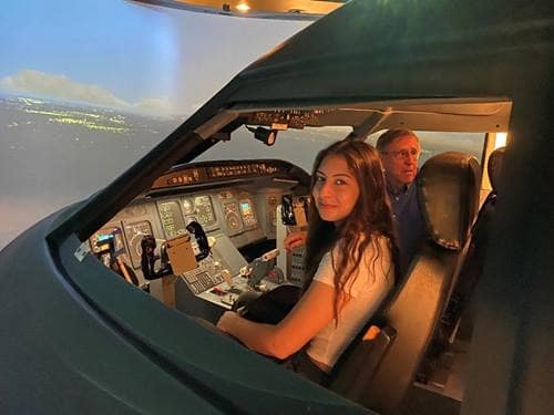 Woman in a CRJ-200 simulator.