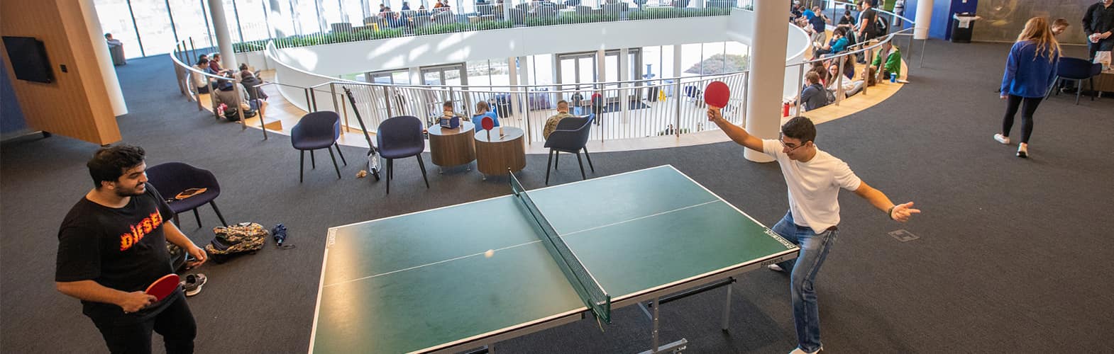 Students play ping pong in the Student Union