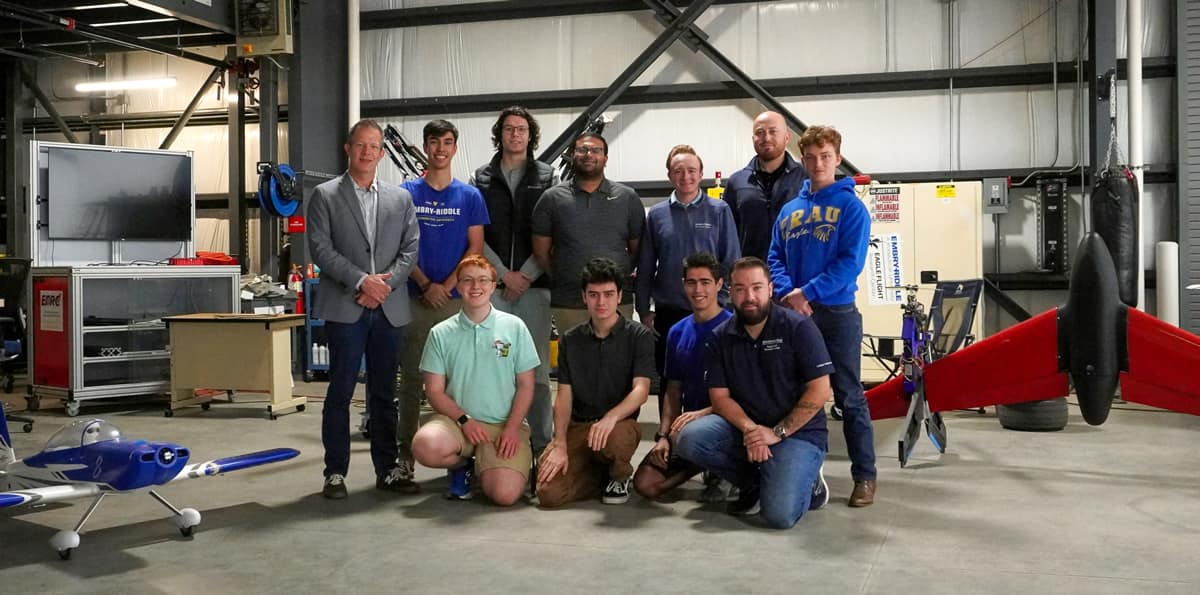 An Embry-Riddle student team is building a compact emergency response aircraft for the GoAERO competition. Here, the team, along with Dr. Kyle Collins (far left), stands in the Eagle Flight Research Center hangar.