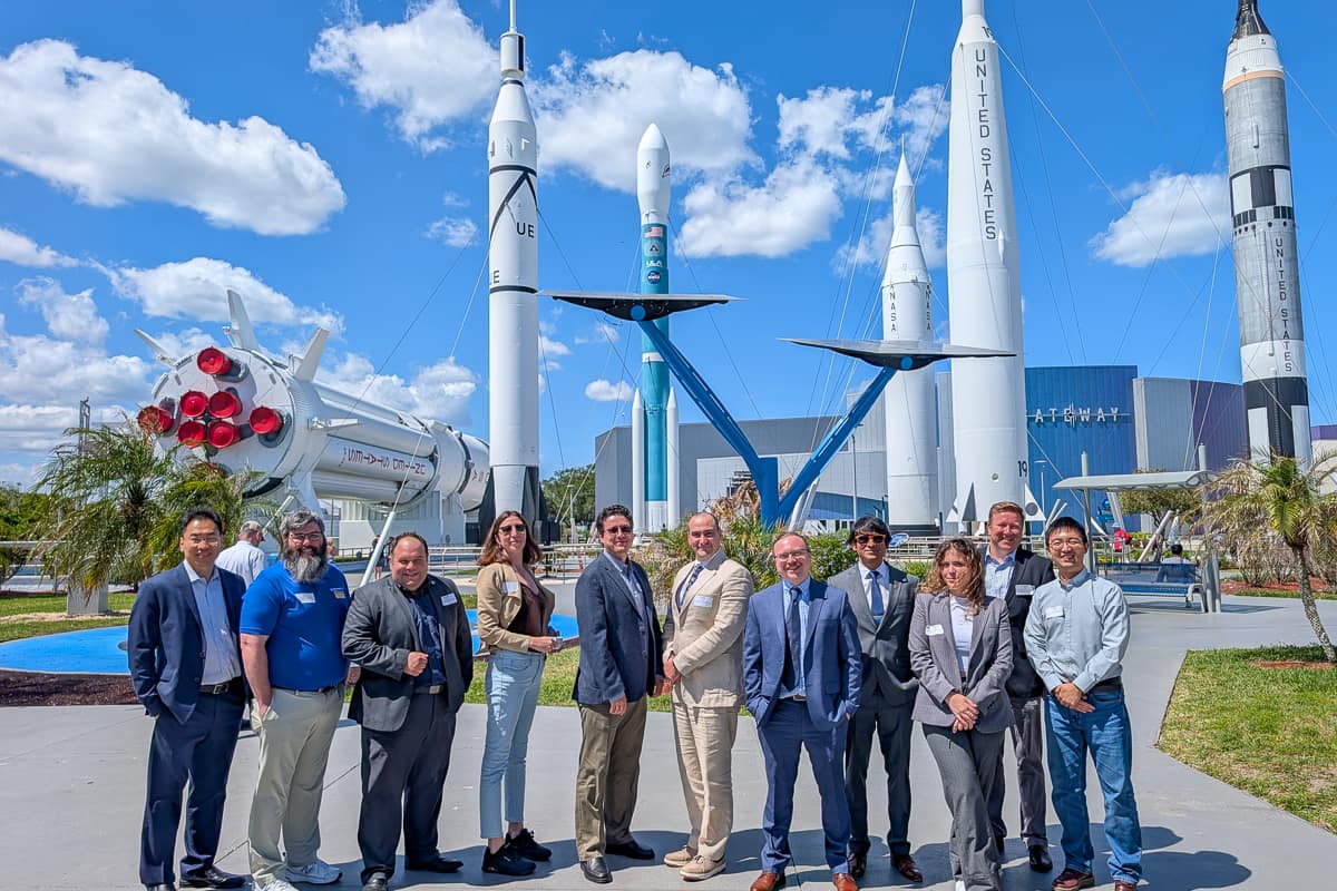 Group in front of NASA rockets at Kennedy Space Center