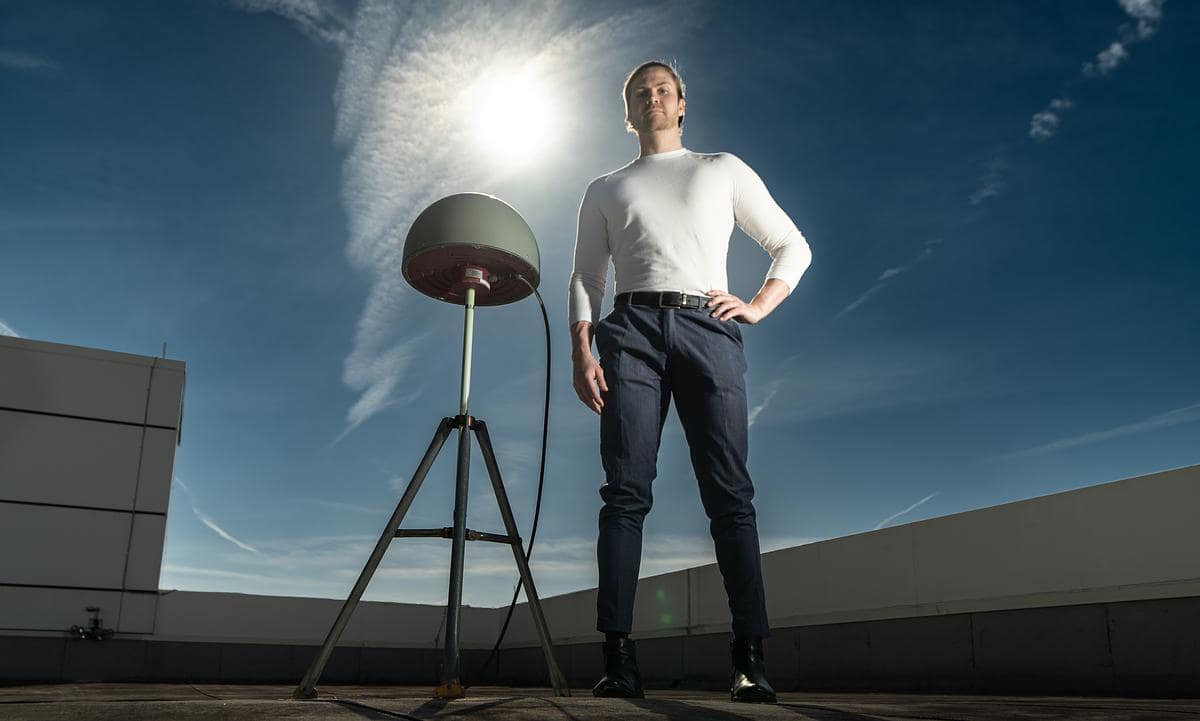 Engineering Physics Ph.D. candidate Björn Bergsson stands next to one of several high-precision Global Navigation Satellite System antennas on the roof of Embry-Riddle’s College of Arts and Sciences.