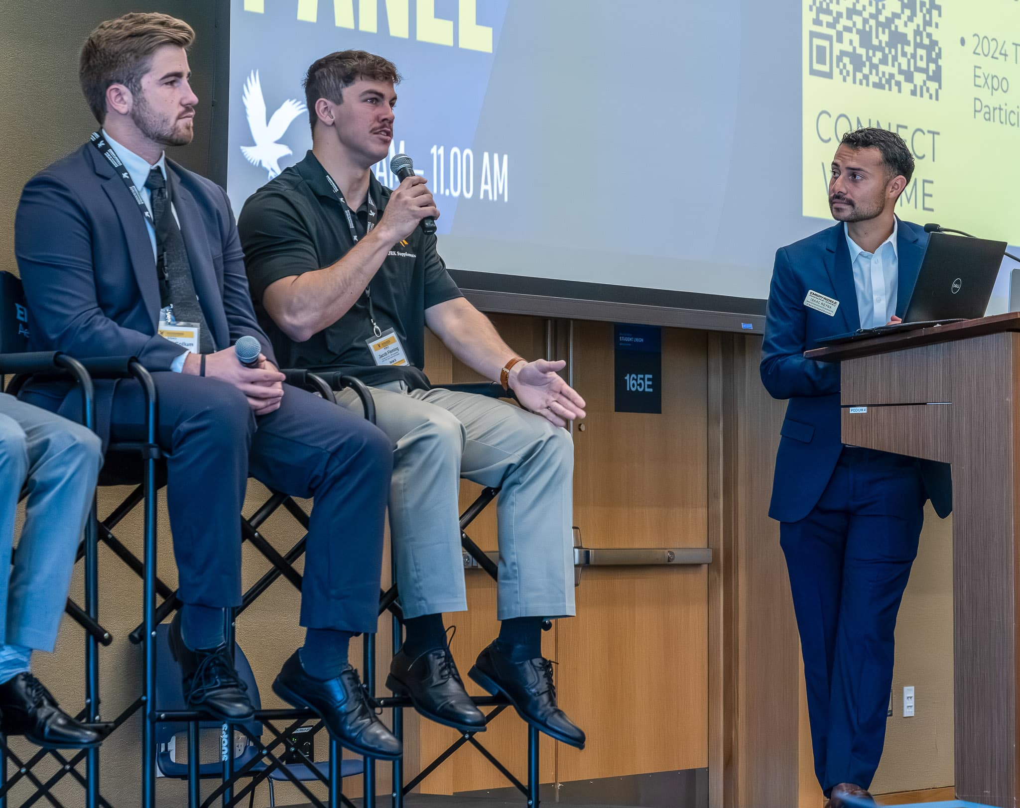 Student Jacob Fleming responds to a question on a panel at Embry Riddle ’s TREP Entrepreneurship Expo, as Aiden McCollum (left) and moderator Isaac Reyna (right) listen. Fleming and McCollum were among five Embry-Riddle student entrepreneurs who shared their experiences on a panel moderated by Reyna, who is a Center for Innovation and Entrepreneurship student ambassador and Business Administration and Management student.