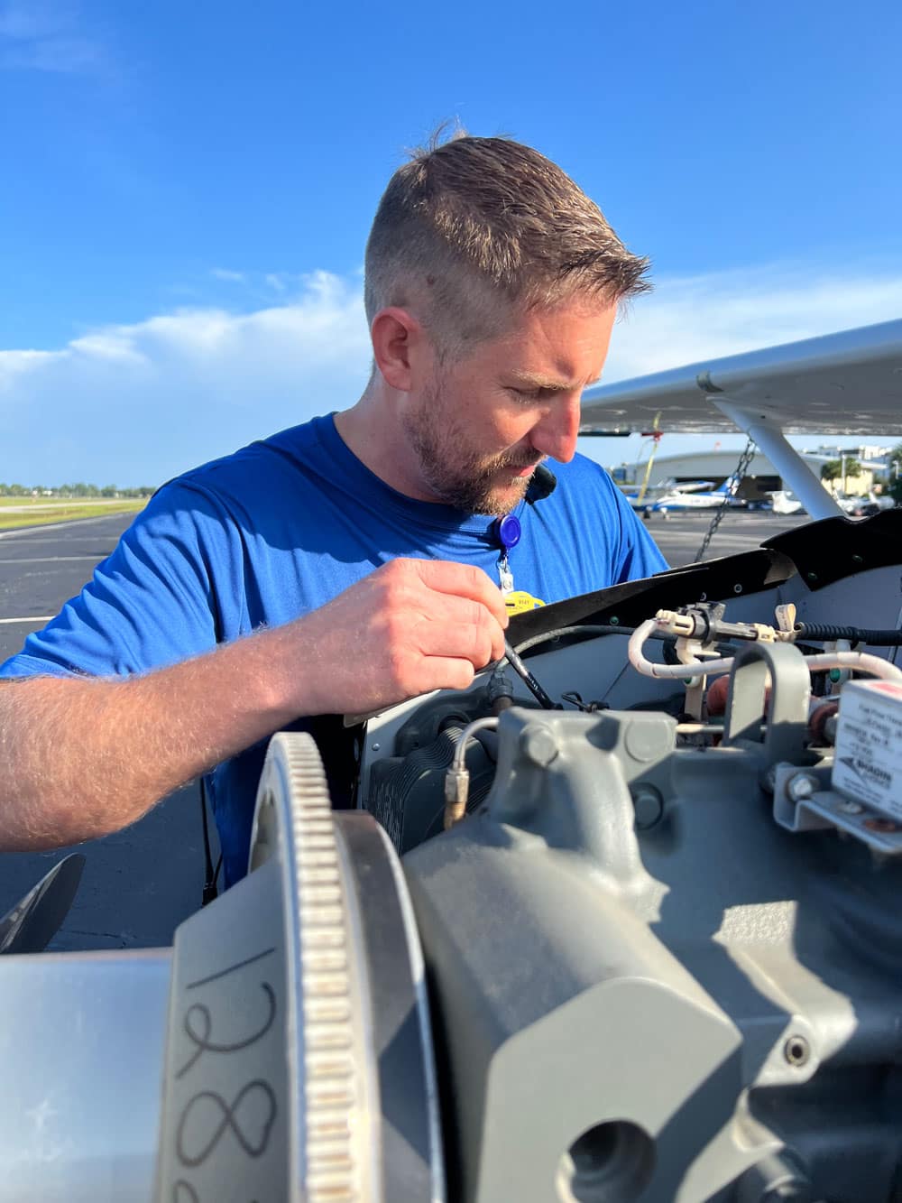 Daniel Stinelli works on a plane engine