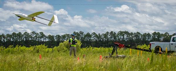 Michael Zebehazy,  UAS Maintenance and Inventory Manager and Crew Chief, left and Austin Noble, student and lab assistant launch the Penguin C UAV platform