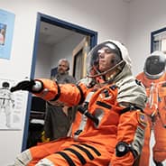 Chase Covello tries out the space suit prior to pressurization